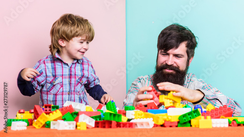 Family is Best. small boy with dad playing together. happy family leisure. father and son play game. building home with colorful constructor. child development. Changing responsibilities