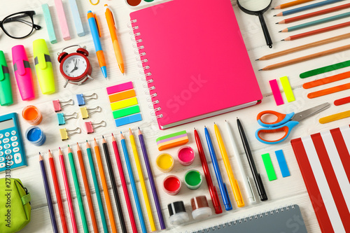 Flat lay composition with school supplies on white wooden background