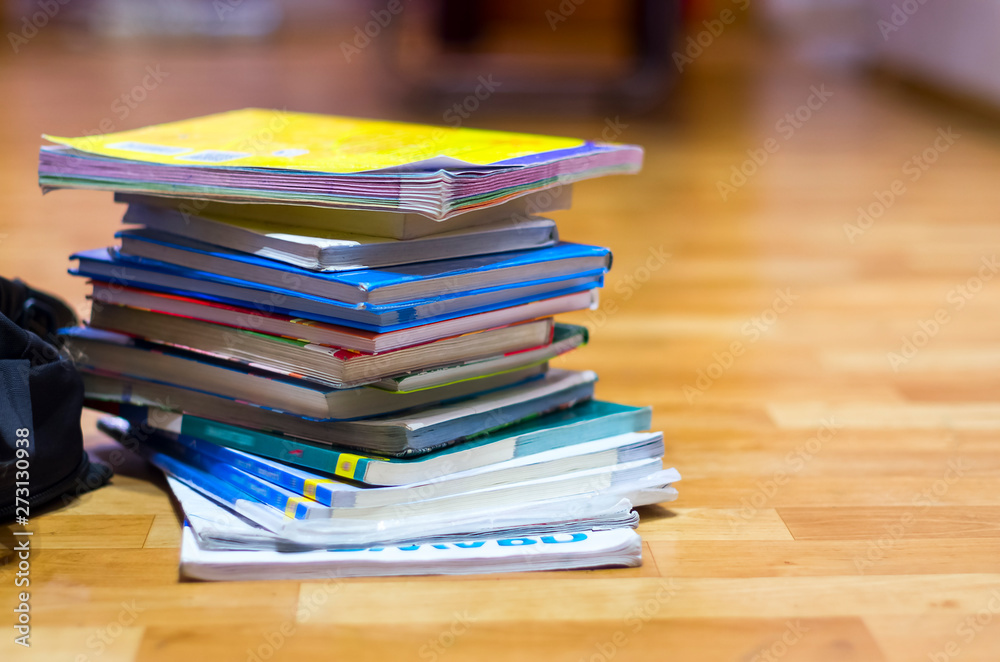 Stack of Textbooks and Black Backpack on Wooden Floor. Education, School Holidays, Back to School Concept. Copy Space. Stack of Textbooks and Black Backpack on Wooden Floor. Education, School Holidays, Back to School Concept. Copy Space.