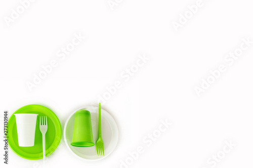 Wallpaper Mural Light green and white set of disposable plastic tableware isolated on white background. Cups, plates and fork. Picnic set. Top view. Free space for text. Torontodigital.ca