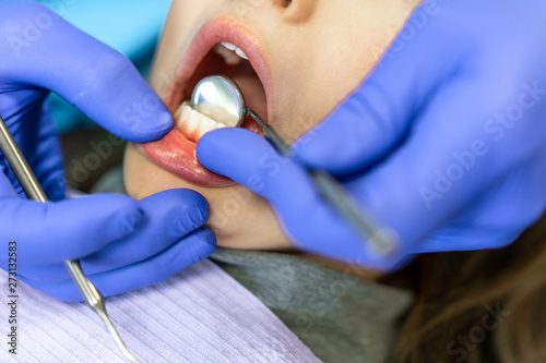 Fototapeta Naklejka Na Ścianę i Meble -  Dental clinic. Reception, examination of the patient. Teeth care. Young woman undergoes a dental examination by a dentist