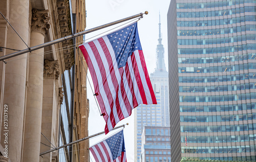 American flag, Manhattan downtown, blur Empire state building on the background