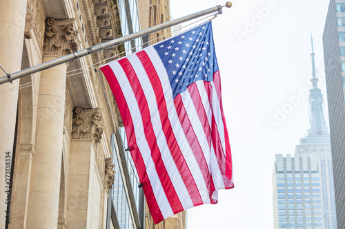 American flag, Manhattan downtown, blur Empire state building on the background