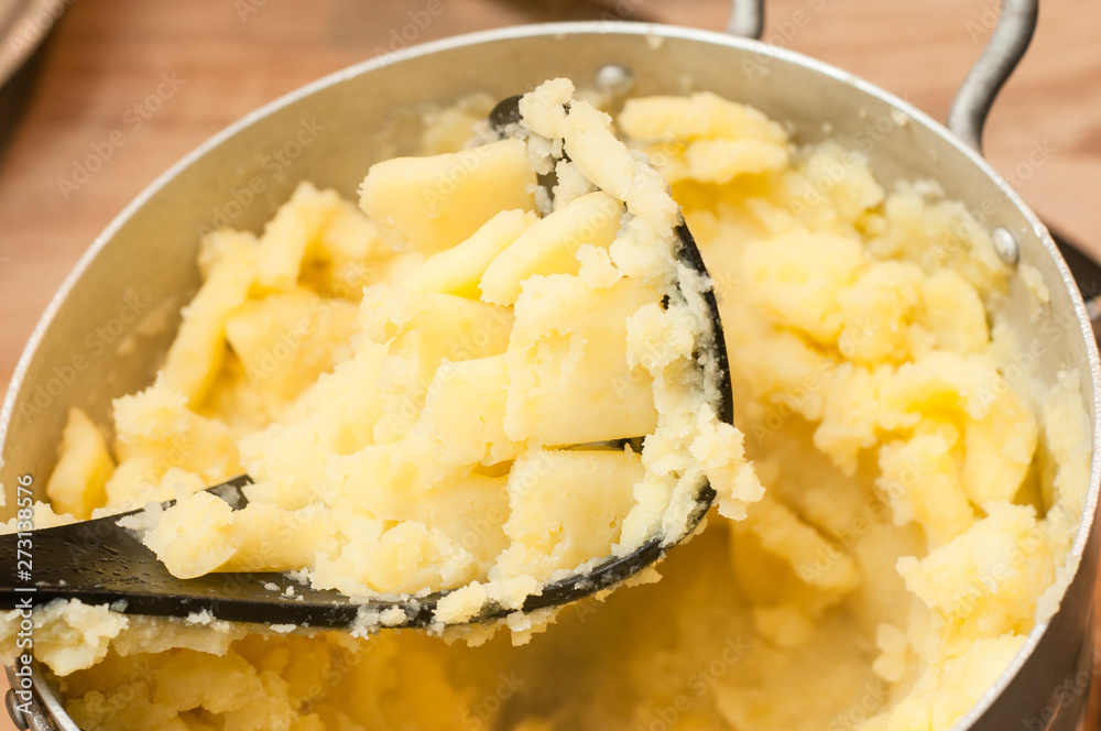 Chopping mashed potatoes with a special press. Hot and delicious dish of homemade potatoes. Chopping mashed potatoes with a special press. Hot and delicious dish of homemade potatoes.