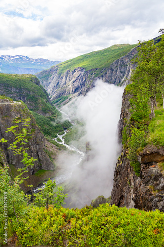 Falls in mountains of Norway. Waterfall Voringfossen - the fourth highest peak in Norway. Voringsfossen Waterfall. Hordaland  Summer Holiday in Norway Scandinavia.