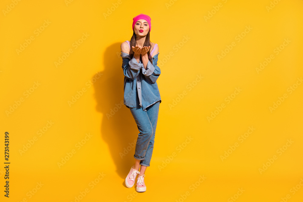 Full length body size photo beautiful funny she her teen lady long hairdo hands arms open palms send air kisses lipstick wear casual jeans denim jacket shoes pink hat isolated yellow bright background Full length body size photo beautiful funny she her teen lady long hairdo hands arms open palms send air kisses lipstick wear casual jeans denim jacket shoes pink hat isolated yellow bright background