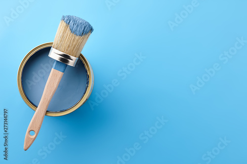 Fototapeta Naklejka Na Ścianę i Meble -  Brush and can of blue paint on blue background, copy space