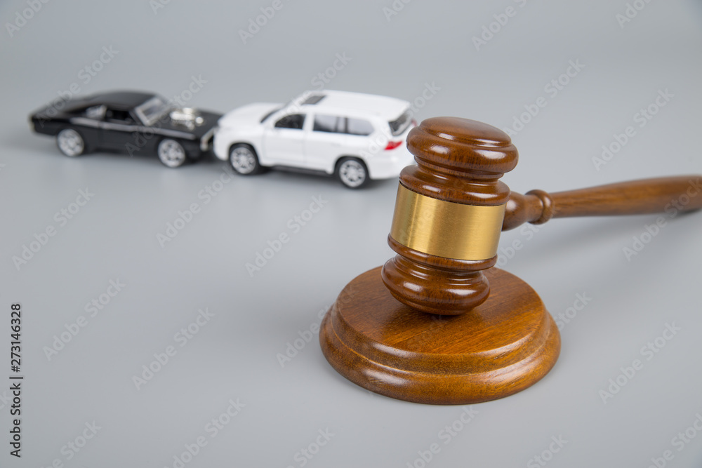 hammer of the judge. two collided cars on a gray background. accident, accident. Insurance, court case hammer of the judge. two collided cars on a gray background. accident, accident. Insurance, court case