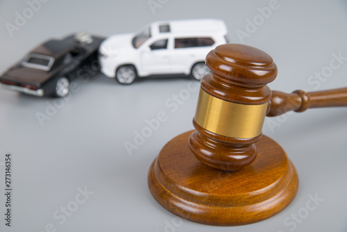 hammer of the judge. two collided cars on a gray background. accident, accident. Insurance, court case photo