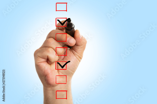 Closeup of man drawing tick