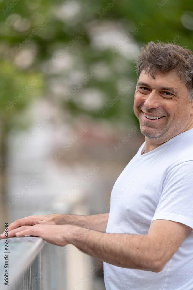 Confident and happy looking man looking at the camera outdoors Confident and happy looking man looking at the camera outdoors