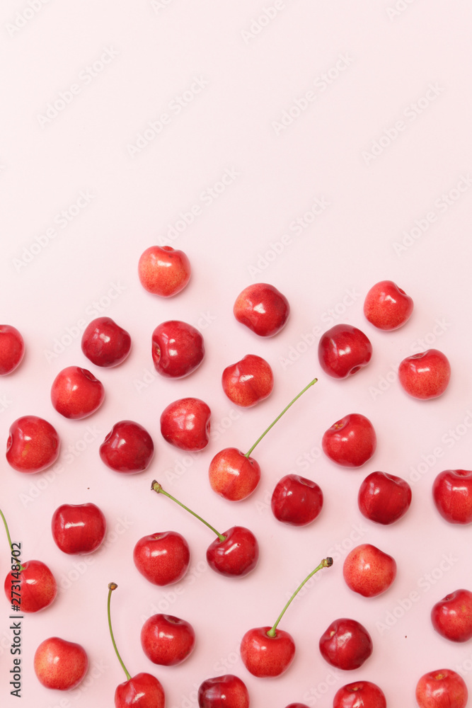 Sweet cherries on pink background, top view Sweet cherries on pink background, top view
