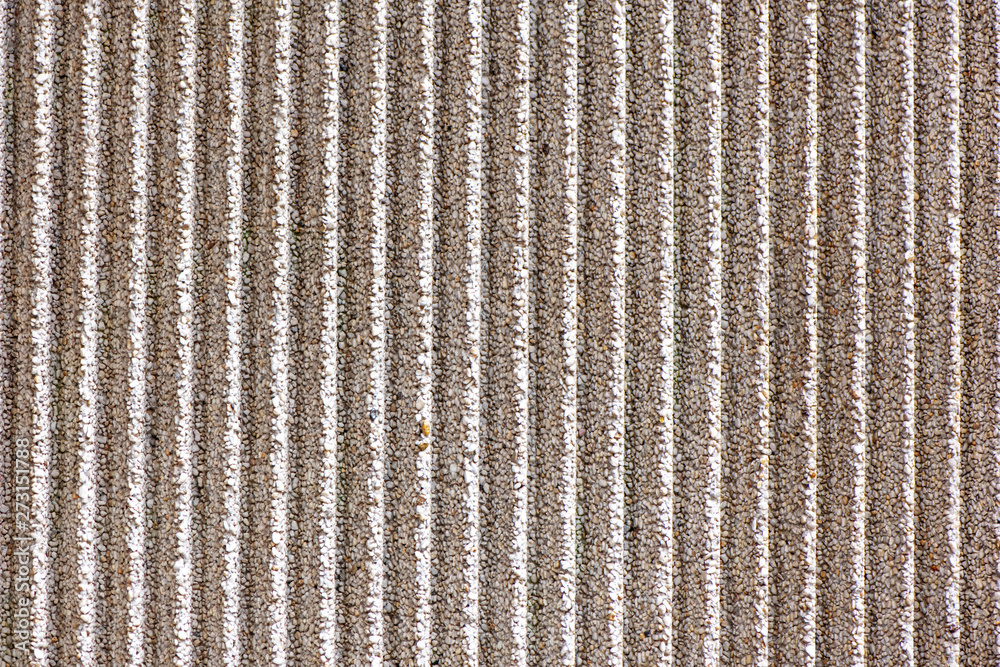 Textured concrete wall with vertical lines as a texture or background ...