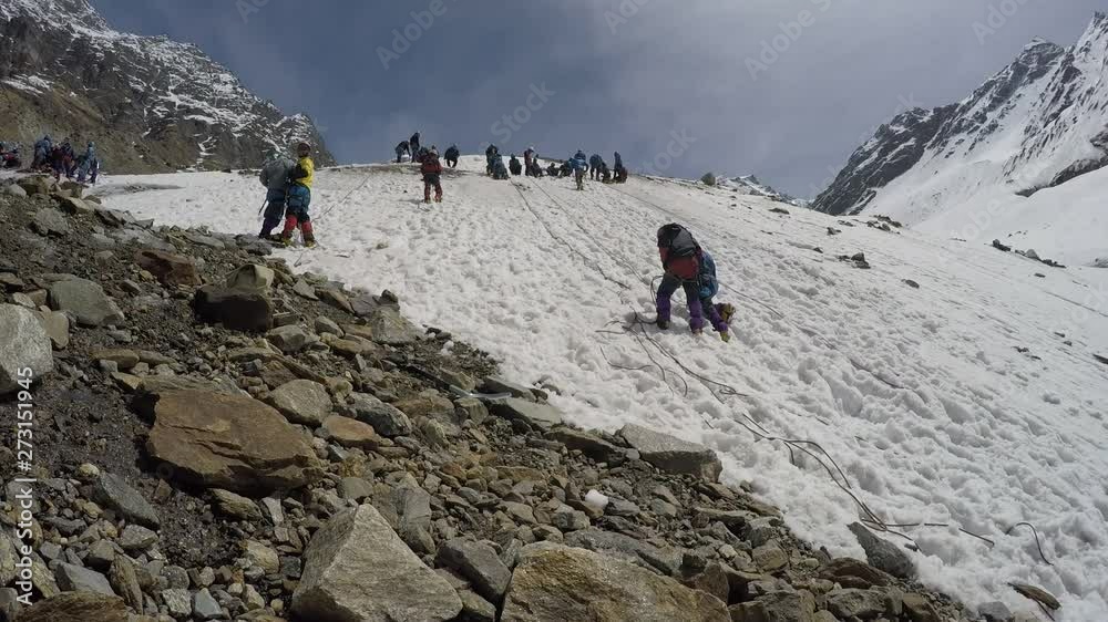 Group of Himalayan mountaineers ready to summit a Himalayan peak during snowfall, upper Himalayas, Uttarakhand, India. The view is mesmerized like paradise.
