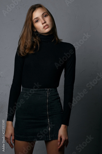 Test shooting for pretty young model wearing denim skirt and black sweater