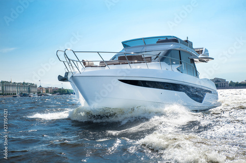 white yacht at river in city, luxury lyfe