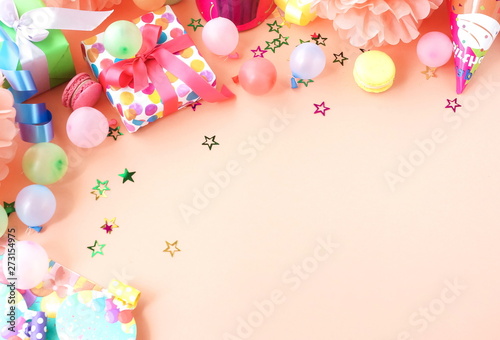 Party background top view.  Festive , birthday multicolored decorations on coral color background . Flat lay style. Copy space