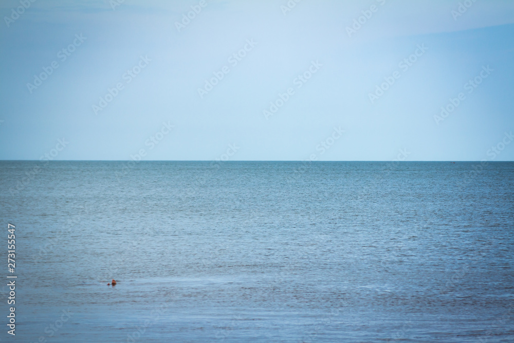 View of the horizon in the sea. Cloudless sky melting with the sea.