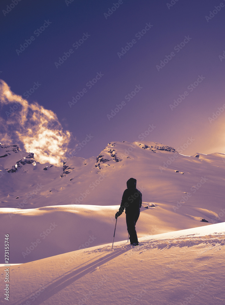 Ski Tour in the austrian alps - man looking at mountains 