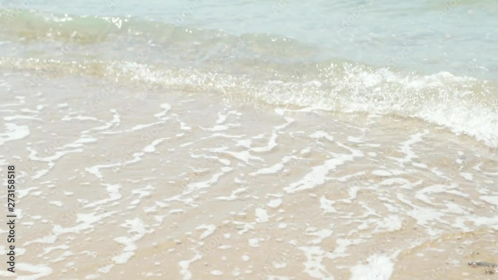 Close-up, waves wash over the sandy beach by the ocean sea, slow motion, relaxation, vacation, travel, tropical Close-up, waves wash over the sandy beach by the ocean sea, slow motion, relaxation, vacation, travel, tropical