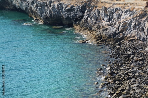 Soft focus of beautiful aerial view of rocky shore with blue sea and cliff in summer time. Nature and outdoor concept.