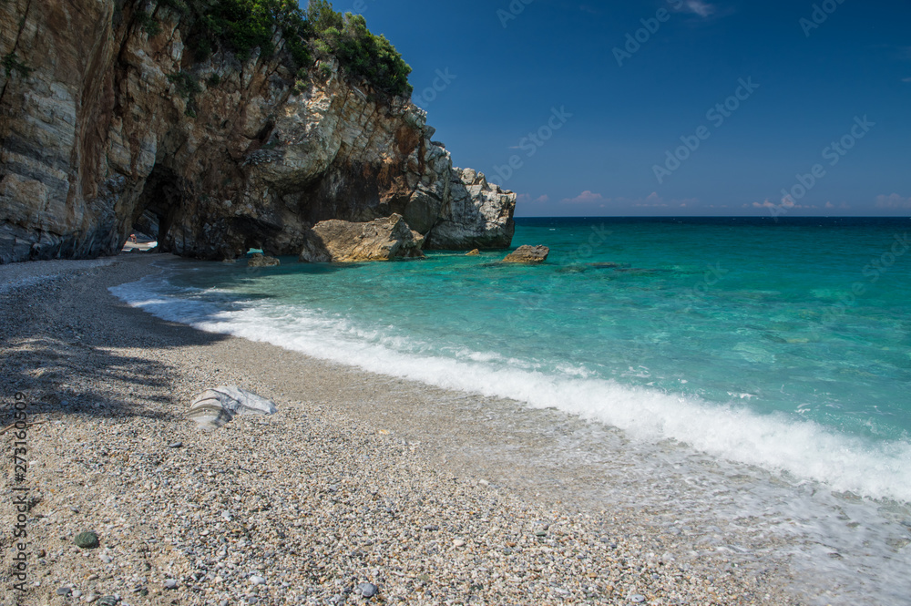 Milopotamos beach in Greece. Rocky cliffs and clear turquoise sea
