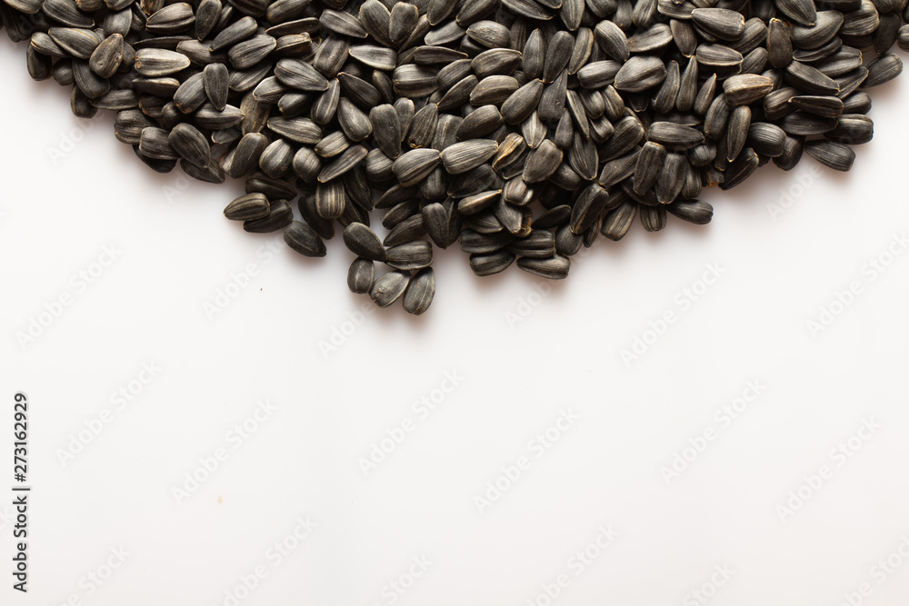 Sunflower seeds, On a white background, with a negative space for writing text or design Sunflower seeds, On a white background, with a negative space for writing text or design