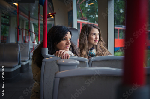 Friends riding in public transportation. Looking through the window