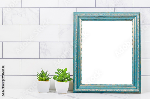 Blank blue vintage photo frame with cactus. © gamjai