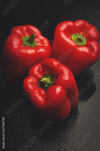 red fresh raw pepper in the studio on a dark background