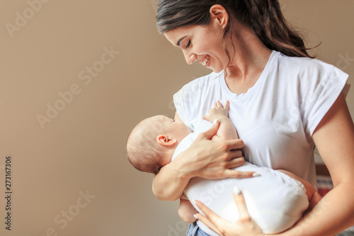 Mother hugging and carrying her baby boy.Tries to put baby to sleep.