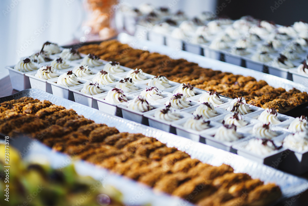 Sweet desserts, pastries on the table during the event. Catering servicing of guests and participants during mass events.