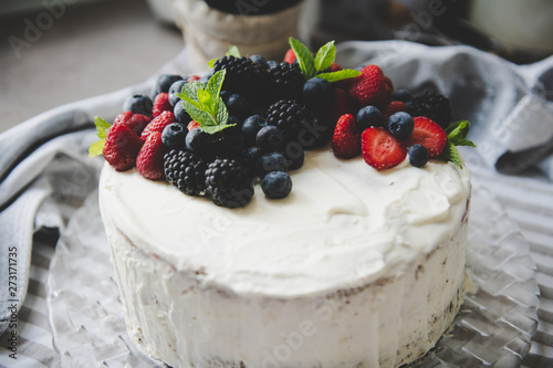 beautiful white cream cheese cake with different summer berries