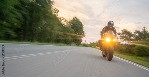 motorbike on the road riding. having fun riding the empty road on a motorcycle tour / journey