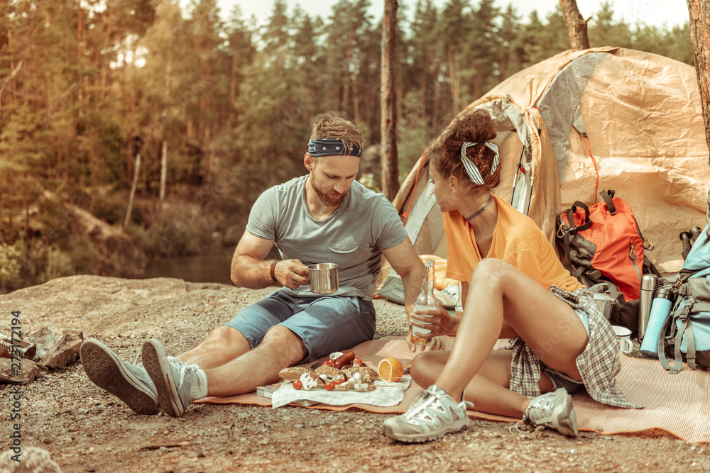 Pleasant young couple enjoying their nice picnic
