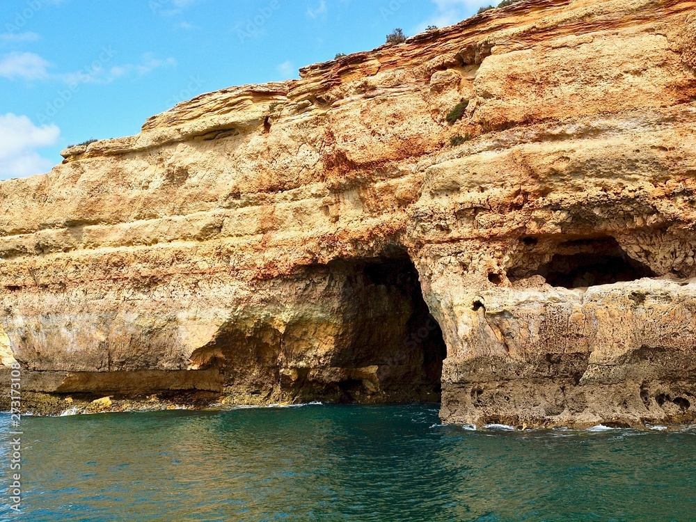 Beautiful cliffs and caves in blue ocean in Albufeira at the Algarve coast of Portugal