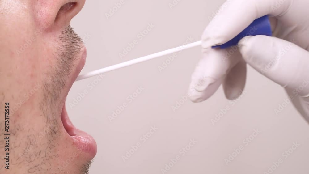 Doctor getting saliva test sample using a swab in medical laboratory. Close-up demonstration. Isolated, on blurred background, copy space
