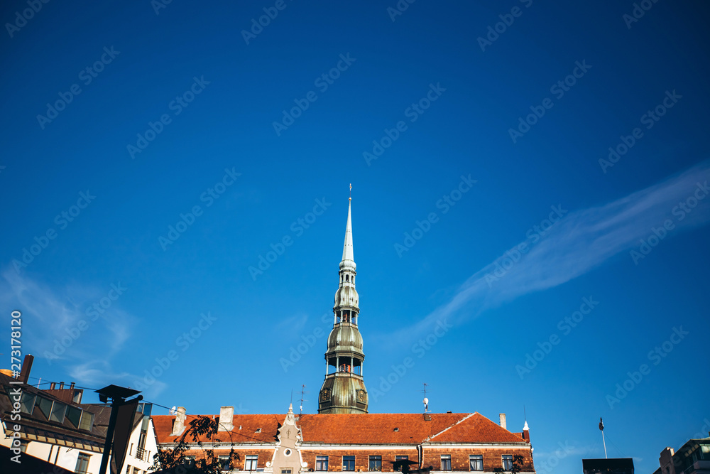 St. Peter's tower wide angle. Sunny weather with blue sky. St. Peter's Church in the historical center of Riga. Latvia St. Peter's tower wide angle. Sunny weather with blue sky. St. Peter's Church in the historical center of Riga. Latvia