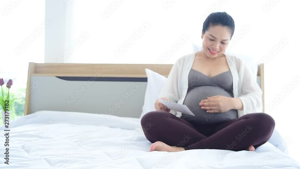 The pregnant woman put hand touch her belly,for love and care of mother The pregnant woman put hand touch her belly,for love and care of mother