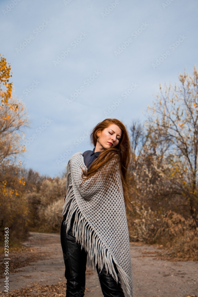 Young redhead woman with scarf in autumn park Young redhead woman with scarf in autumn park