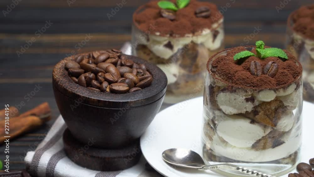 Classic tiramisu dessert in a glass on wooden background Classic tiramisu dessert in a glass on wooden background