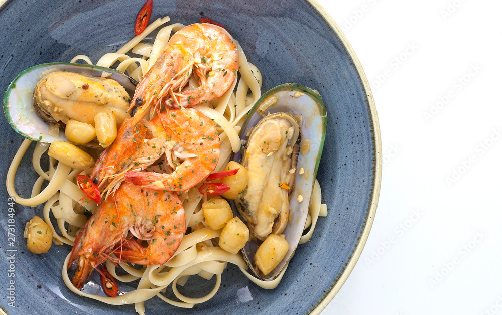 Closeup Spicy Spaghetti With Shrimps And Mussels on Plate and White Background .Thai Style.. Closeup Spicy Spaghetti With Shrimps And Mussels on Plate and White Background .Thai Style..