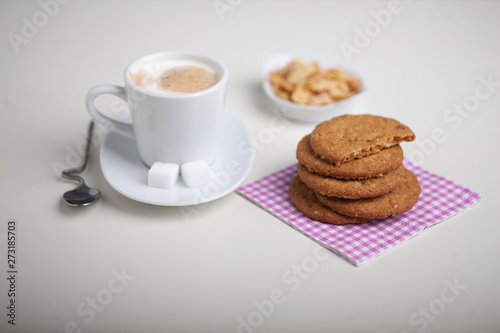 cup of coffee and cookies on table