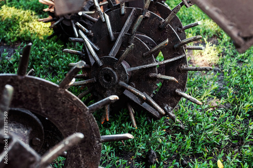 Agriculture, tractor with iron plow cultivator. Close-up.
