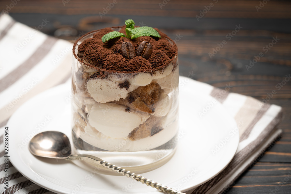 Classic tiramisu dessert in a glass on wooden background Classic tiramisu dessert in a glass on wooden background