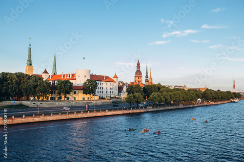 Panoramic view of the Old Town from the cable-stayed bridge to the Daugava embankment at sunset. Riga, Latvia. Riga Castle with the Riga Cathedral in front of. St. Peter's Church in the background.