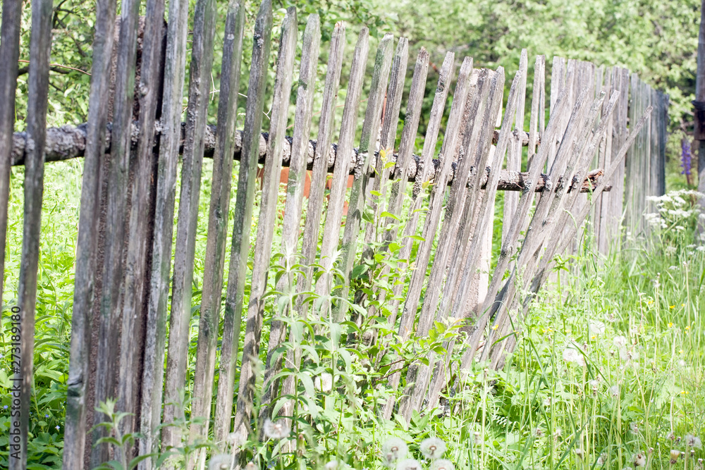 old shaky wooden picket fence closeup view on outdoor nature background old shaky wooden picket fence closeup view on outdoor nature background
