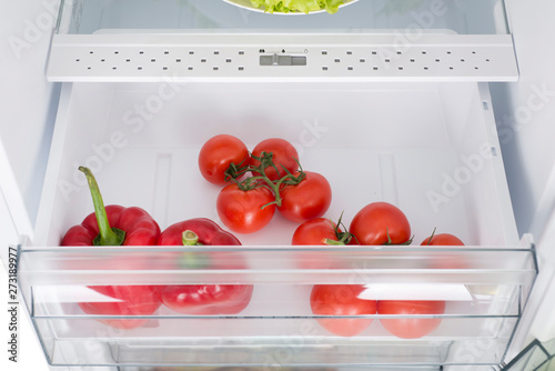 Open fridge full of fresh fruits and vegetables