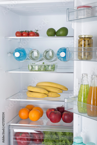 Open fridge full of fresh fruits and vegetables