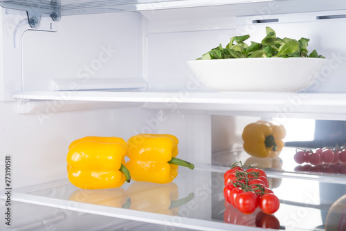 Open fridge full of fresh fruits and vegetables